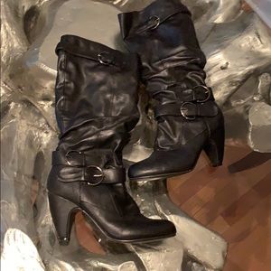 Black zip up boot with buckles.